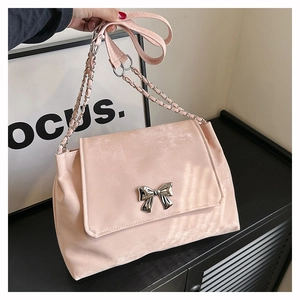 Large soft PU crossbody bag in dusty rose featuring a metallic bow and chain strap