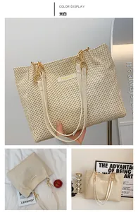 Detailed close-up of off-white woven tote bag featuring fashion metal logo and dual straps