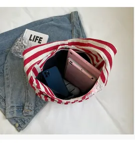 Interior view of red and white striped canvas tote showing spacious capacity for electronics