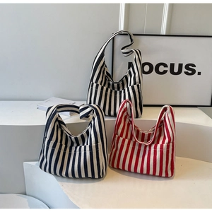 Retro striped canvas tote bags in black and red on a minimalist white art display
