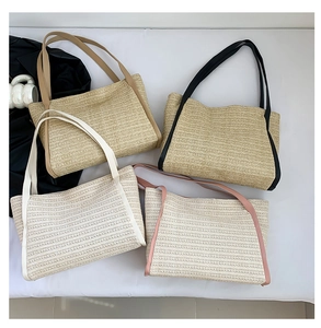 Flat lay of woven straw tote bags in various colors with matching leather straps