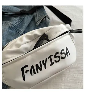 Close-up of white crossbody bag showing front pocket and black FANYISSA logo detail