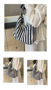 Detail shot of navy striped canvas tote bag showing thick texture and wide shoulder strap