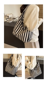 Detail of a large capacity striped canvas tote bag showing the textured fabric and wide strap
