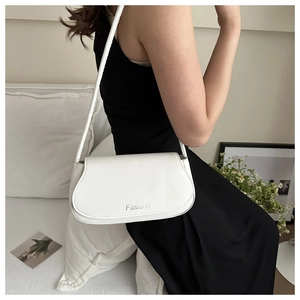 Detail of white minimalist underarm saddle bag with silver Fashion lettering and flap