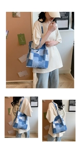 Detail of patchwork denim tote bag showing multi-tone blue squares and stitching quality