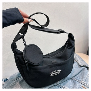 Detail of black nylon crescent crossbody bag with mini pouch and logo plaque