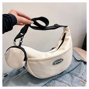 Detail of off-white nylon crescent crossbody bag with mini pouch and adjustable strap