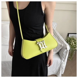 Neon green leather crescent shoulder bag with metallic gothic buckle on model