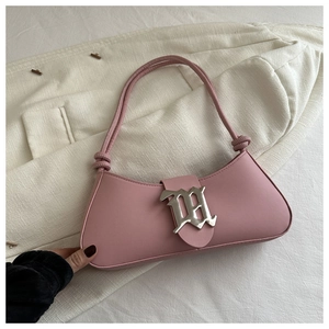 Close-up of pink baguette handbag with silver gothic buckle and knot handle detail