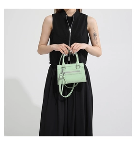 Vue détaillée du sac bandoulière vert menthe avec garnitures argentées chic