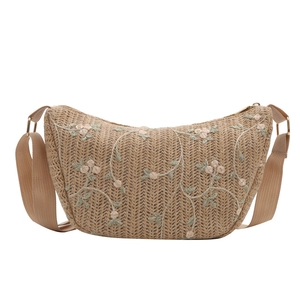 Embroidered floral straw crossbody bag with crescent moon shape and wide fabric strap