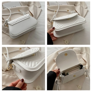 Detail of white quilted faux leather underarm bag with gold magnetic clasp and interior view