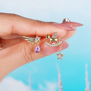 Asymmetric gold star and unicorn earring set with purple gems and crescent moon