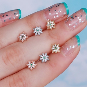 Star-shaped cartilage studs with green zircon in rose gold, silver, and gold finish