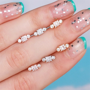 Three-color baguette cut zircon stainless steel cartilage stud earrings set shown on hand
