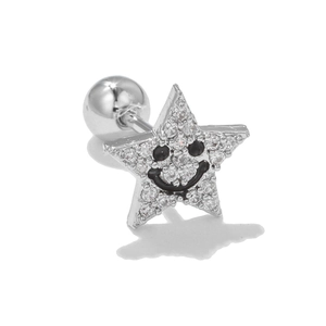 Close-up of silver star stud earring with white zircon and black enamel smiley face
