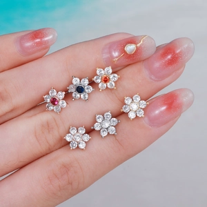 Minimalist flower tragus studs in stainless steel with colorful cubic zirconia stones
