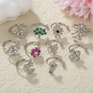 Flat lay of 10-piece silver ear cuff set with colorful zircons and nature motifs
