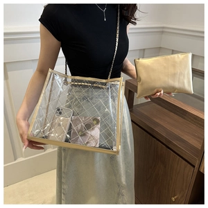 Détail du sac cabas transparent en PVC avec surpiqûres dorées et pochette intérieure amovible