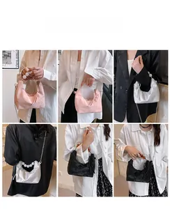 Detailed view of the beaded handle and soft ruched texture on this stylish PU leather handbag