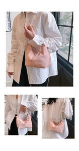 Pink hobo handbag featuring a faux leather gathered texture and beaded handle detail