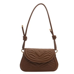 Brown chevron quilted shoulder bag with heart pattern and gold hardware on white background
