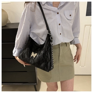 Soft black PU leather shoulder bag featuring a silver butterfly buckle and pleated texture
