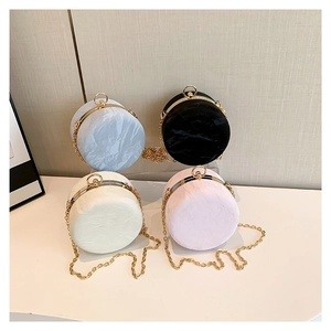 Minimalist round cylinder crossbody bags in four pastel colors with gold chain straps