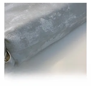 Macro shot of grey textured bucket bag fabric with silver chain and metal ring details