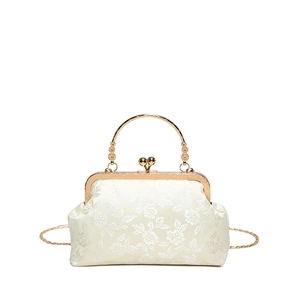 Elegant white floral jacquard frame bag with golden metal handle and chain strap