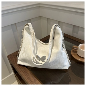 White soft PU leather hobo bag with silver butterfly charm and chain shoulder strap