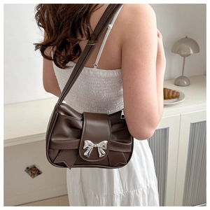 Dark brown ruched underarm bag with a silver metal bow buckle for stylish women