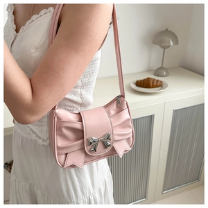 Pink bow shoulder bag with pleated faux leather texture and silver bow buckle detail