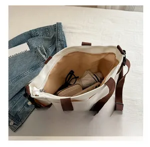 Top view of large white canvas tote bag showing spacious interior with multiple pockets