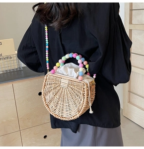 Detail of semi-circular rattan bag featuring colorful acrylic bead chain and drawstring