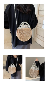 Detailed close-up of woven straw handbag with elegant pearl handle and drawstring lining