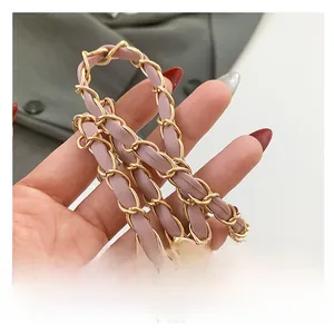 Detail of pink leather woven with gold metal chain strap for women shoulder bag