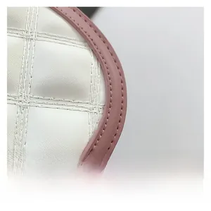 Close-up of quilted cream leather handbag with pink trim and fine stitching detail
