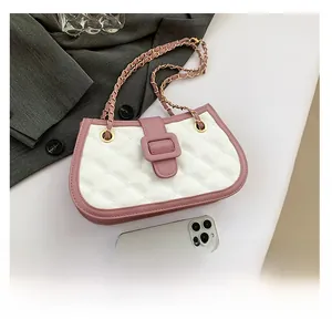 Detailed close-up of pink and white quilted crossbody bag with gold chain strap