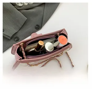 Detail view of the quilted contrast handbag interior showing storage for cosmetics