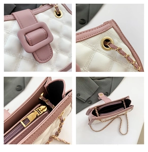Detailed view of pink quilted handbag with gold magnetic buckle and interior zipper pocket
