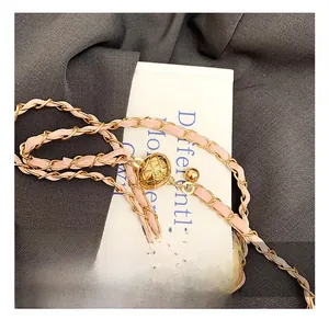 Detail of light pink leather chain strap with gold adjustable metal ball buckle