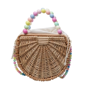 Handwoven straw tote bag with colorful macaron bead handle and canvas drawstring lining