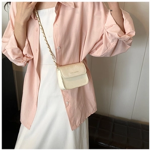 Detail of cream glossy mini crossbody bag with gold chain strap and rich rabbit logo