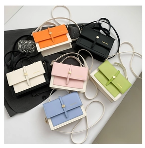 Flat lay view of small square crossbody bags in six vibrant candy colors and gold buckles