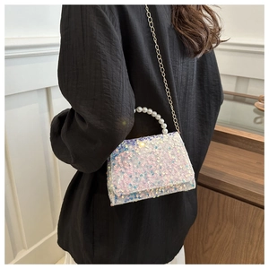 Iridescent sequin handbag with pearl handle and gold chain strap close-up detail