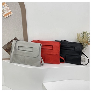 Minimalist soft PU leather shoulder bags in grey, red, and black on a display stand