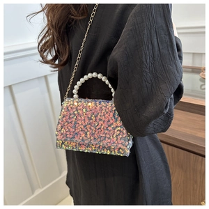 Detail of colorful sequin crossbody bag with white pearl handle and gold chain strap