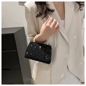 Black sequin handbag with pearl handle and gold chain strap for elegant evening wear
